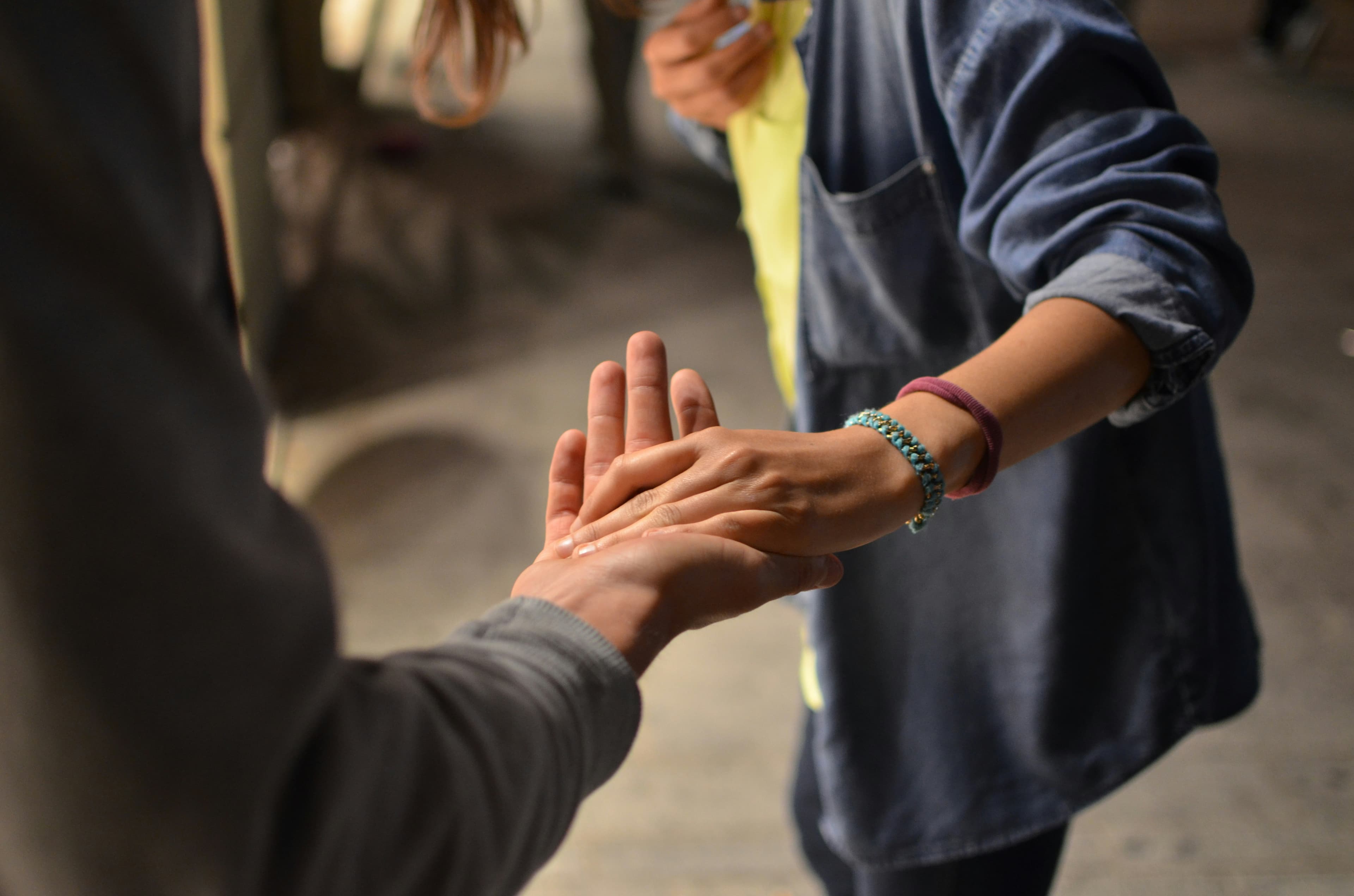 Holding hands with each other, symbolising support and care