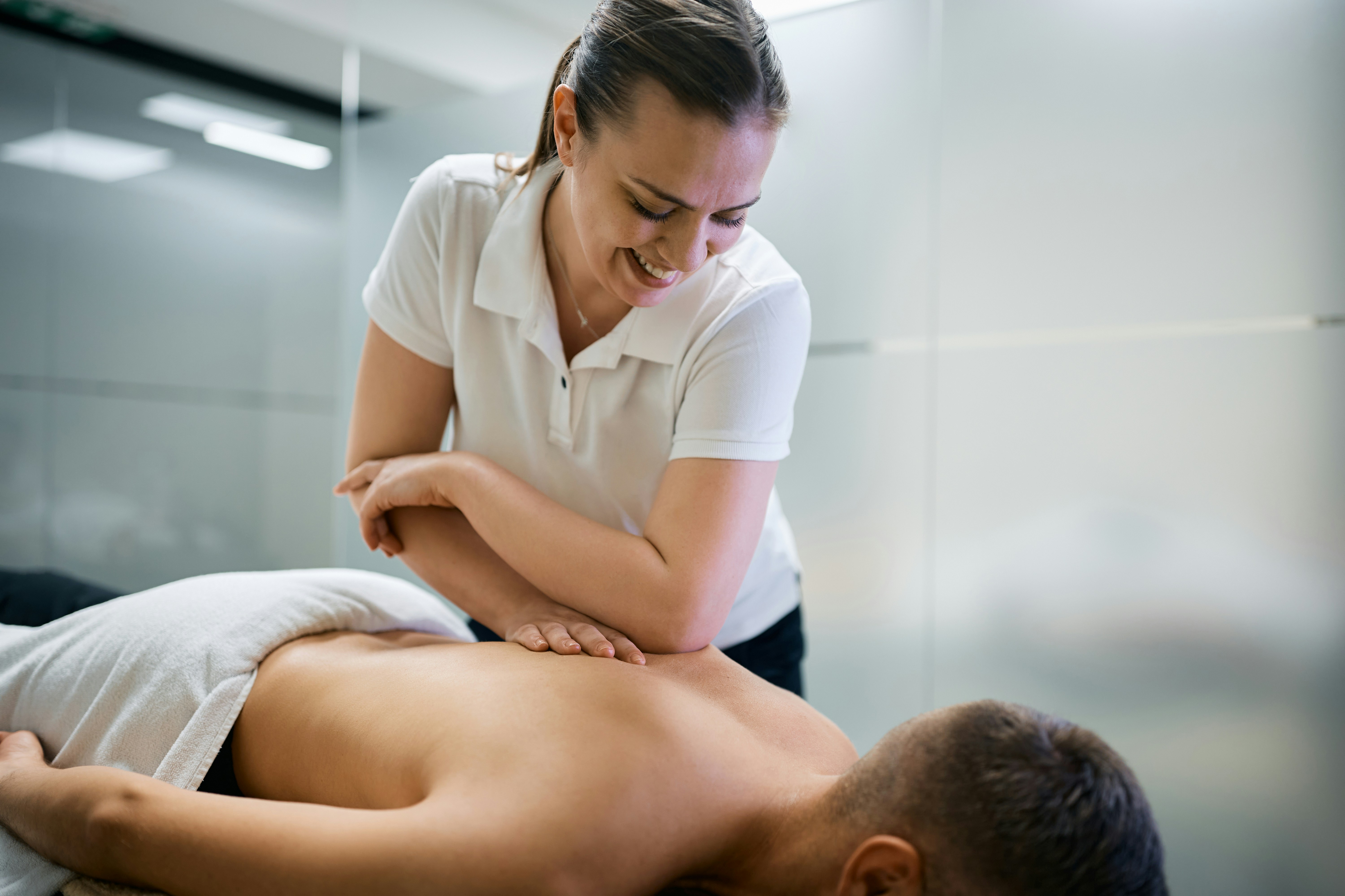 Remedial massage therapist working with a client