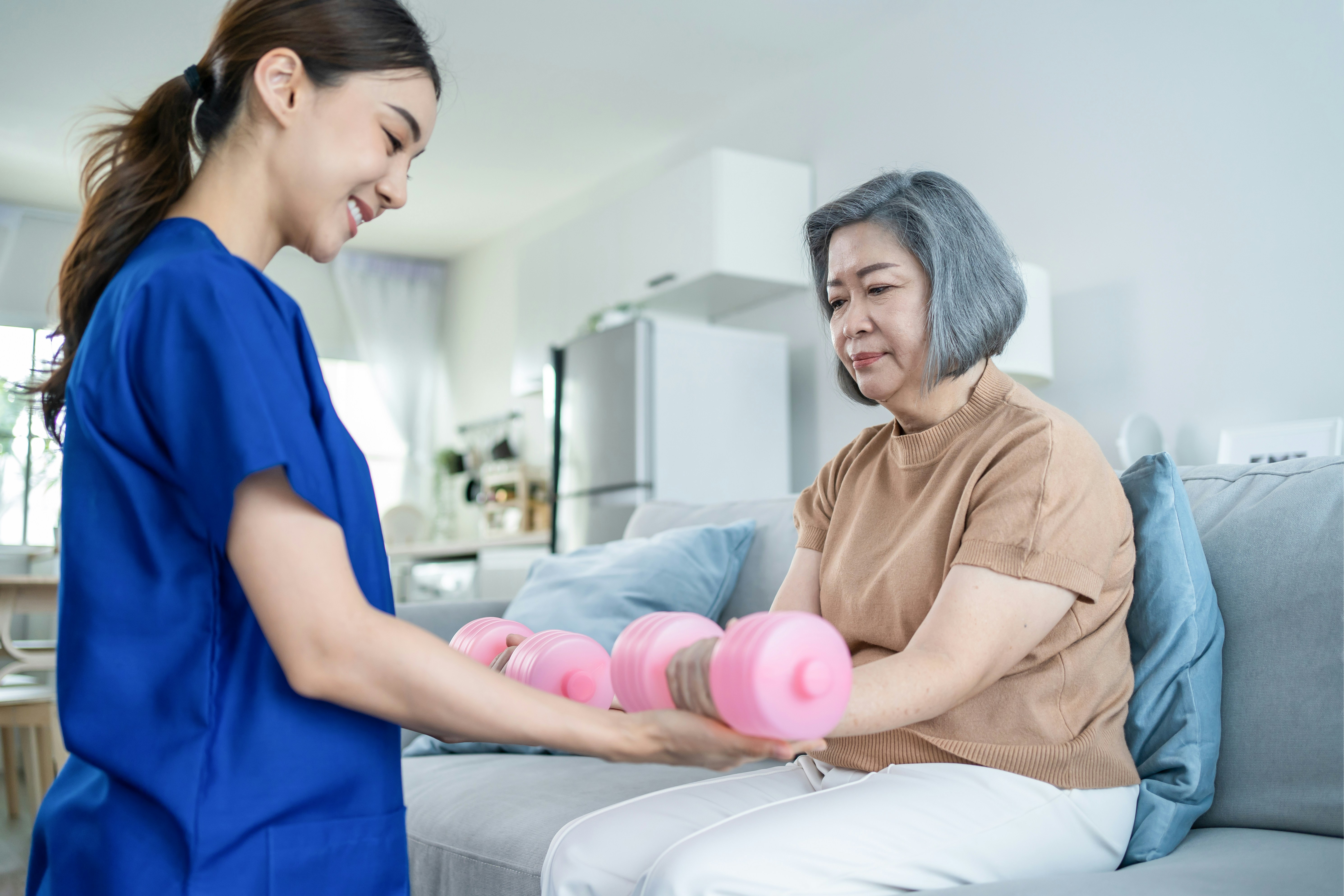 Physiotherapist assisting an elderly person
